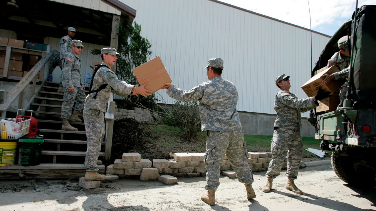 Members of the Texas National Guard drop off food supplies at the First Baptist Church, Tuesday, Sept. 16, 2008, in Crystal Beach, Texas. (Associated Press)