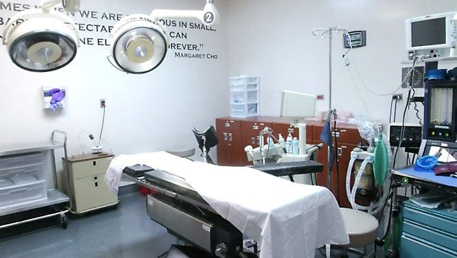 A Texas doctor's office shows a hospital bed and various medical tools. 