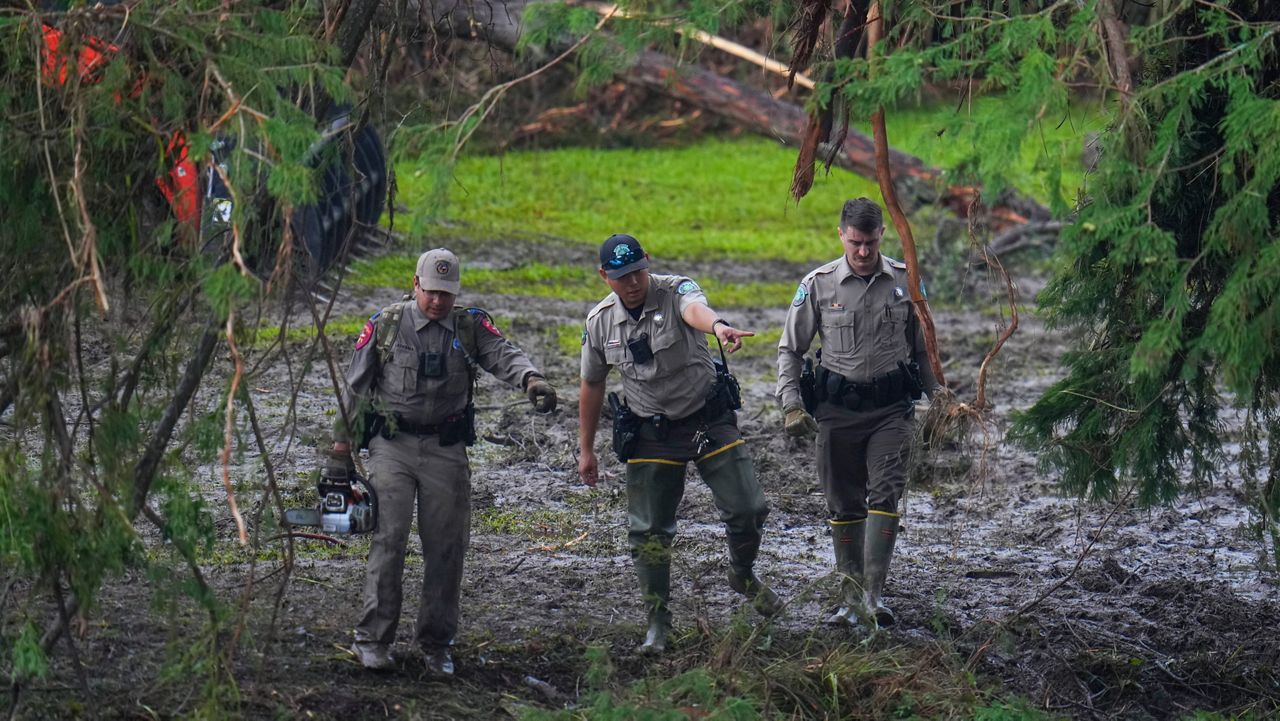 People react as they inspect aOfficials inspect an area at Camp Mystic along the banks of the Guadalupe River after a flash flood swept through the area Sunday, July 6, 2025, in Hunt, Texas. (AP Photo/Julio Cortez)n area outside sleeping quarters at Camp Mystic along the banks of the Guadalupe River after a flash flood swept through the area Sunday, July 6, 2025, in Hunt, Texas. (AP Photo/Julio Cortez)