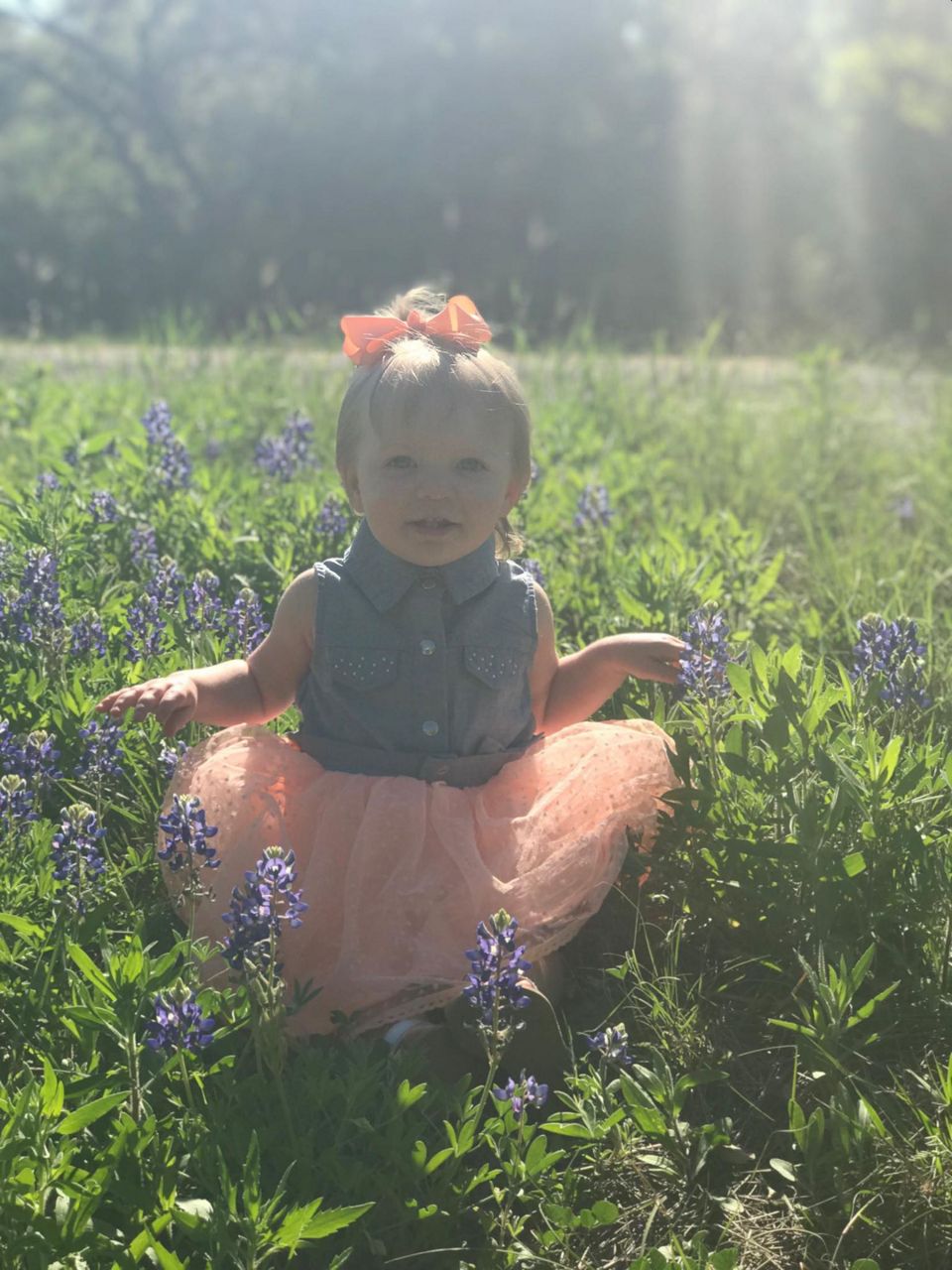 Baby girl in tutu in wildflowers