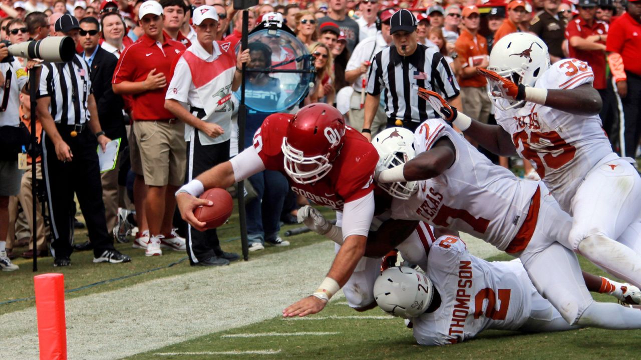Texas and Oklahoma football players compete in this image from 2012. (Associated Press)