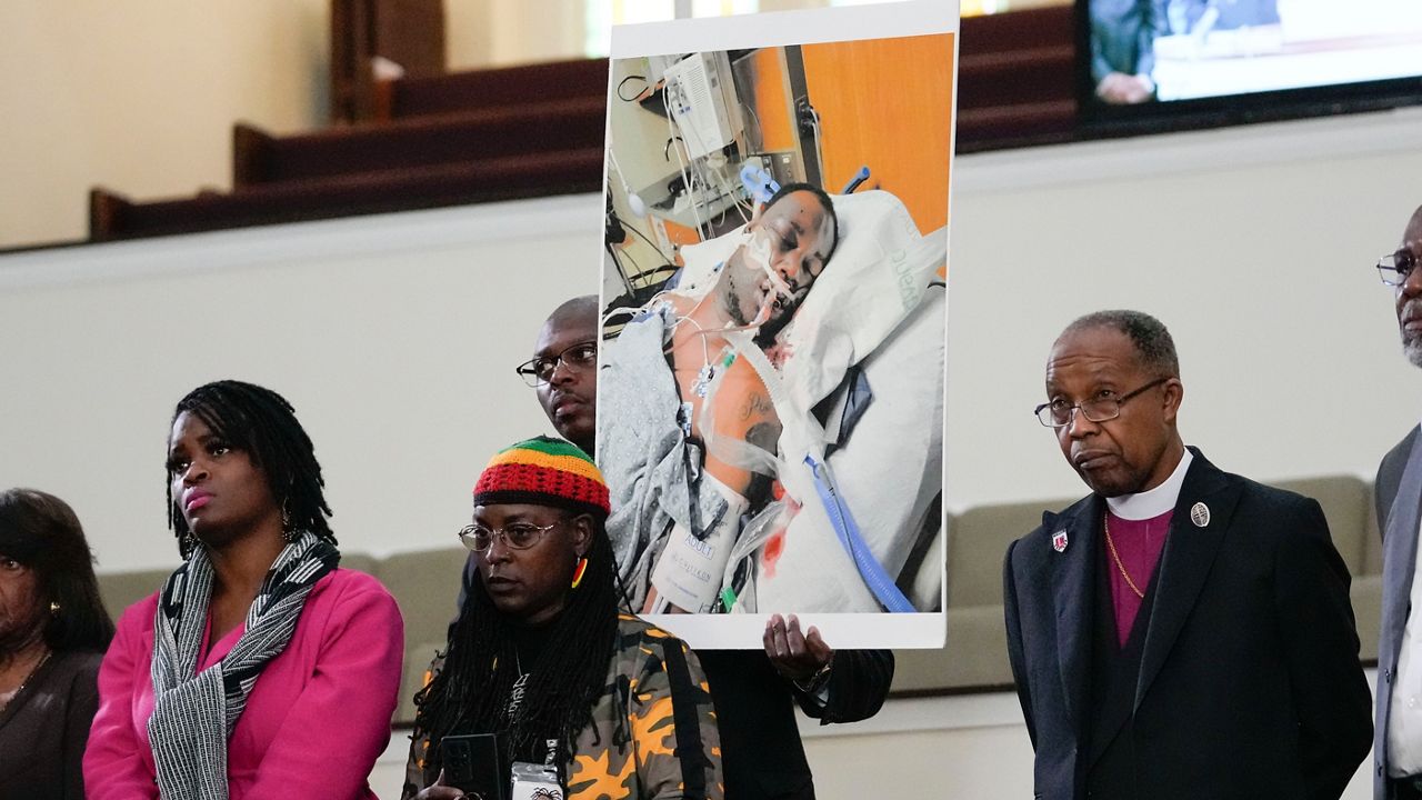 Family members and supporters hold a photograph of Tyre Nichols at a news conference in Memphis, Tenn., Jan. 23, 2023. (AP Photo/Gerald Herbert)