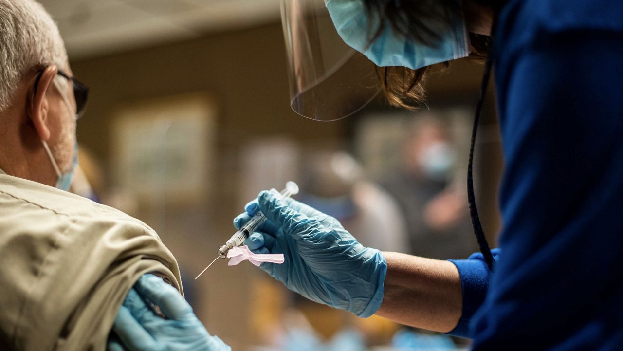 Medical personnel administers a COVID-19 vaccine. (Spectrum News 1/File)