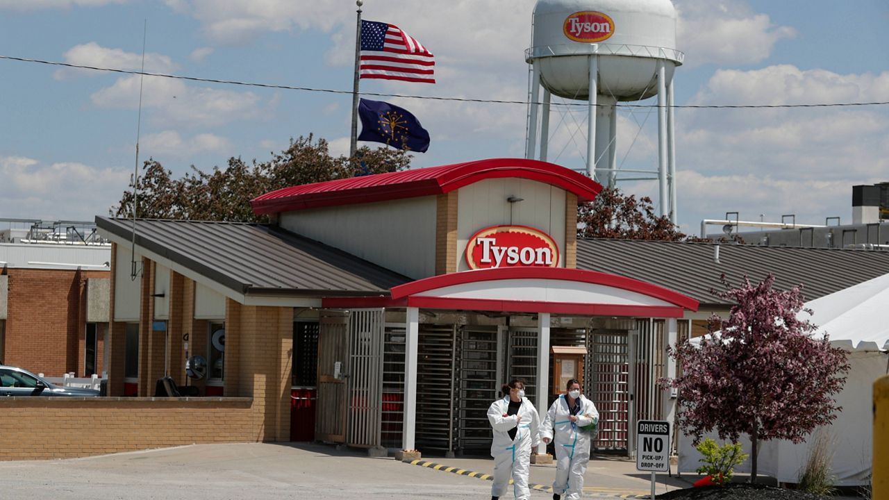 In this May 7, 2020, file photo, workers leave the Tyson Foods pork processing plant in Logansport, Ind. (AP Photo/Michael Conroy, File)