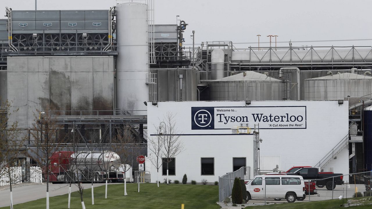 In this May 1, 2020, file photo, vehicles sit in a near empty parking lot outside the Tyson Foods plant in Waterloo, Iowa. (AP Photo/Charlie Neibergall, file)