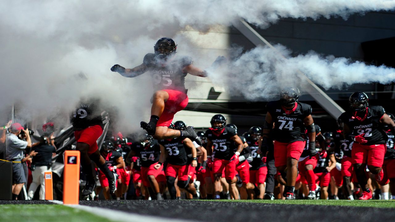 Cincinnati defensive end Justin Wodtly leaps as he takes the field with teammates before an NCAA college football game against Oklahoma, Saturday, Sept. 23, 2023, in Cincinnati. (AP Photo/Aaron Doster)