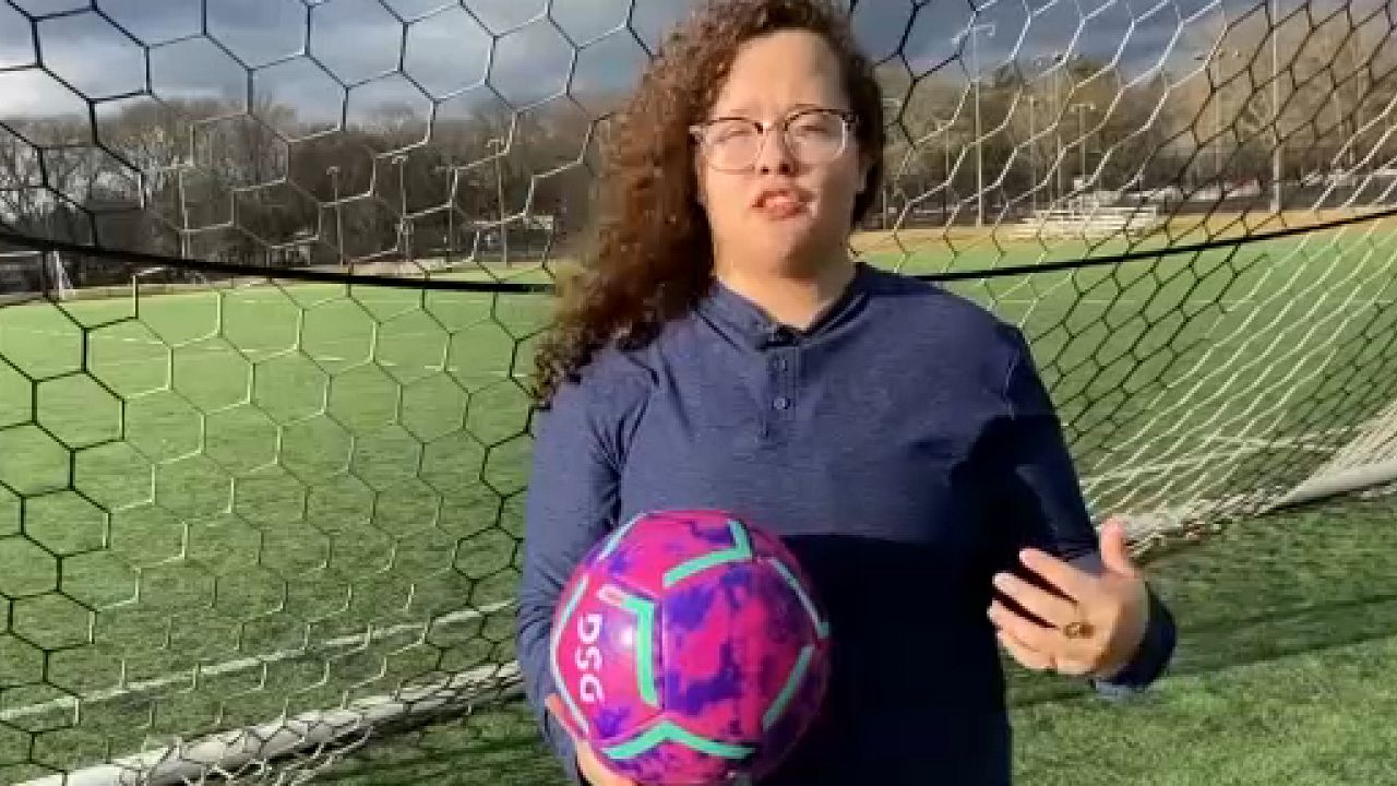 Woman with soccer ball.