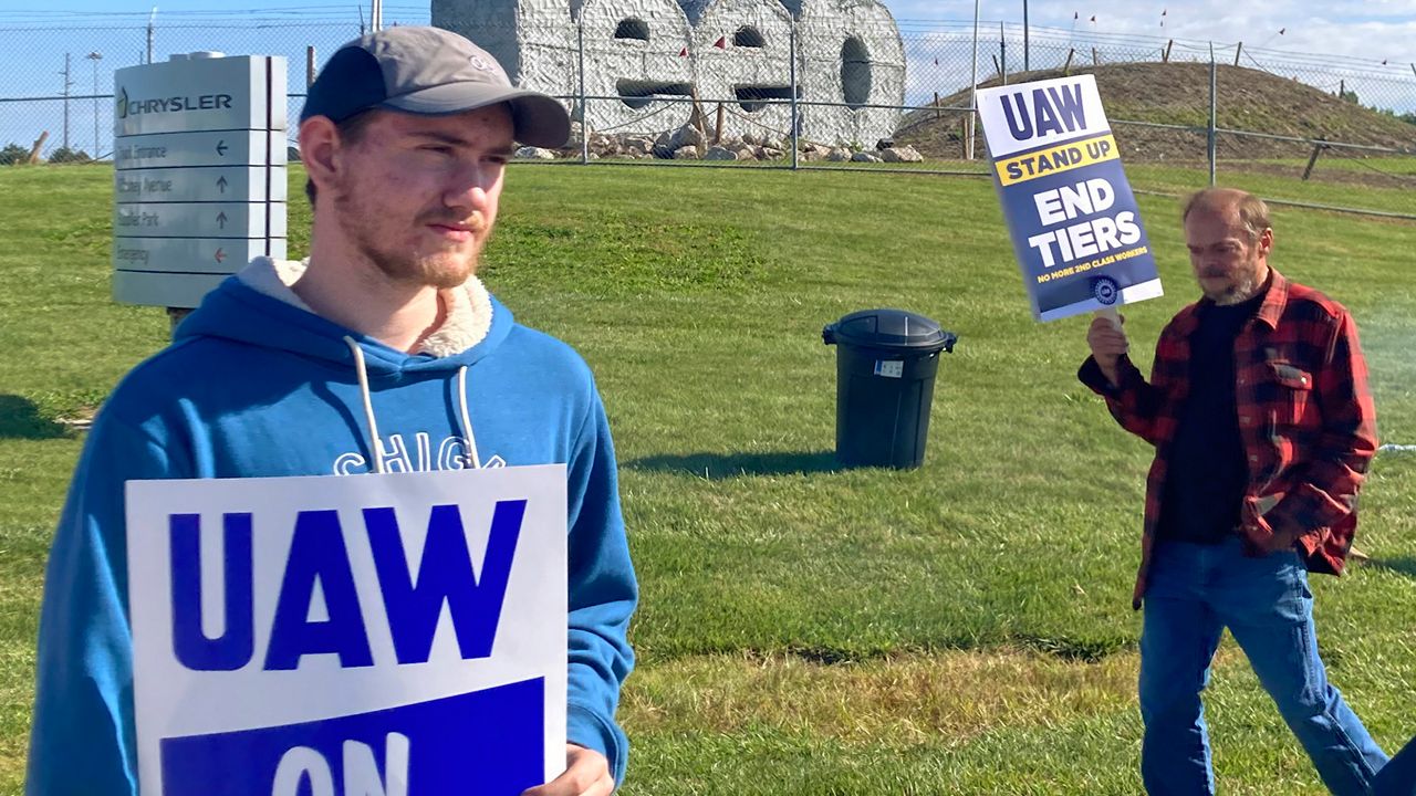 Logan Bohn, a member of the striking United Auto Workers, stands outside the Stellantis plant that makes Jeeps in Toledo, Ohio, on Friday, September 15, 2023. Bohn is a temporary worker at the plant. The UAW is seeking a contract that will end a big disparity in pay for temporary workers. (AP Photo/John Seewer)