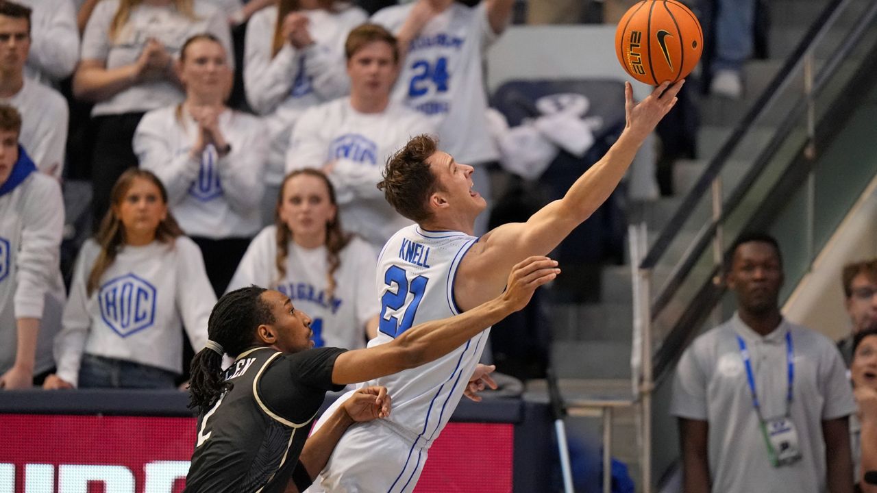 BYU guard Trevin Knell (21) blocks the shot of UCF guard DeMarr Langford Jr. (12) on Feb. 13, 2024. (AP Photo/Rick Bowmer)