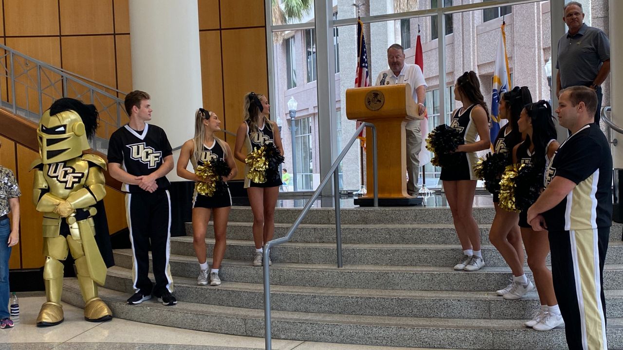 Mayor Buddy Dyer issued an officials proclamation declaring Orlando a Big 12 city and raised the UCF flag outside City Hall on Thursday (Spectrum News/Nick Allen)