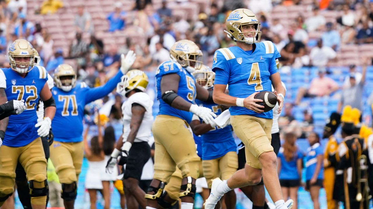 UCLA quarterback Ethan Garbers (4) scores a touchdown during the first half of an NCAA college football game against the Alabama State in Pasadena, Calif., Saturday, Sept. 10, 2022. (AP Photo/Ashley Landis)