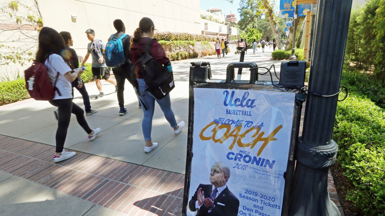 A sign promoting new head basketball coach Mick Cronin and the upcoming basketball season is seen on the campus just after he was introduced as the UCLA's new head basketball coach at a news conference on the campus in Los Angeles Wednesday, April 10, 2019. (AP Photo/Reed Saxon)