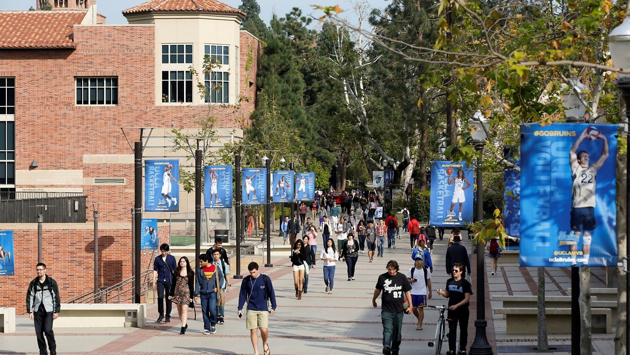 In this Feb. 26, 2015, file photo, students walk on the University of California, Los Angeles campus. (AP Photo/Damian Dovarganes, File)