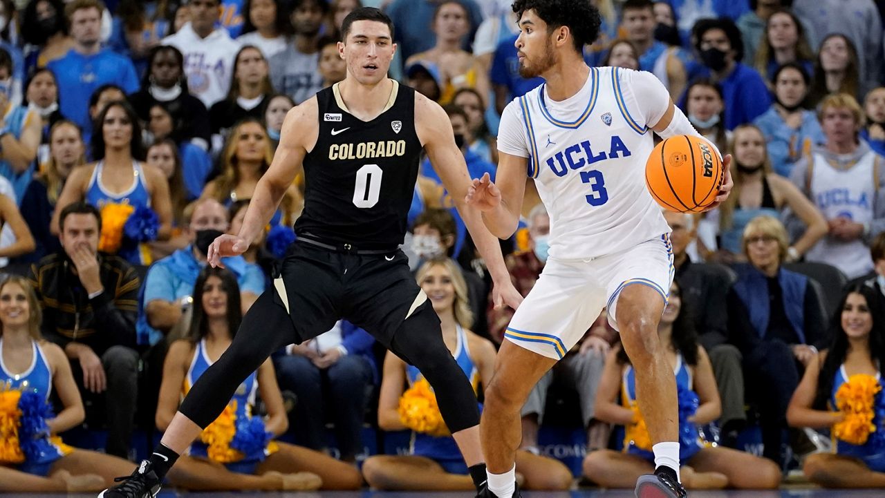Colorado guard Luke O'Brien (0) defends against UCLA guard Johnny Juzang (3) during the first half of an NCAA college basketball game in Los Angeles, Wednesday, Dec. 1, 2021. (AP Photo/Ashley Landis)