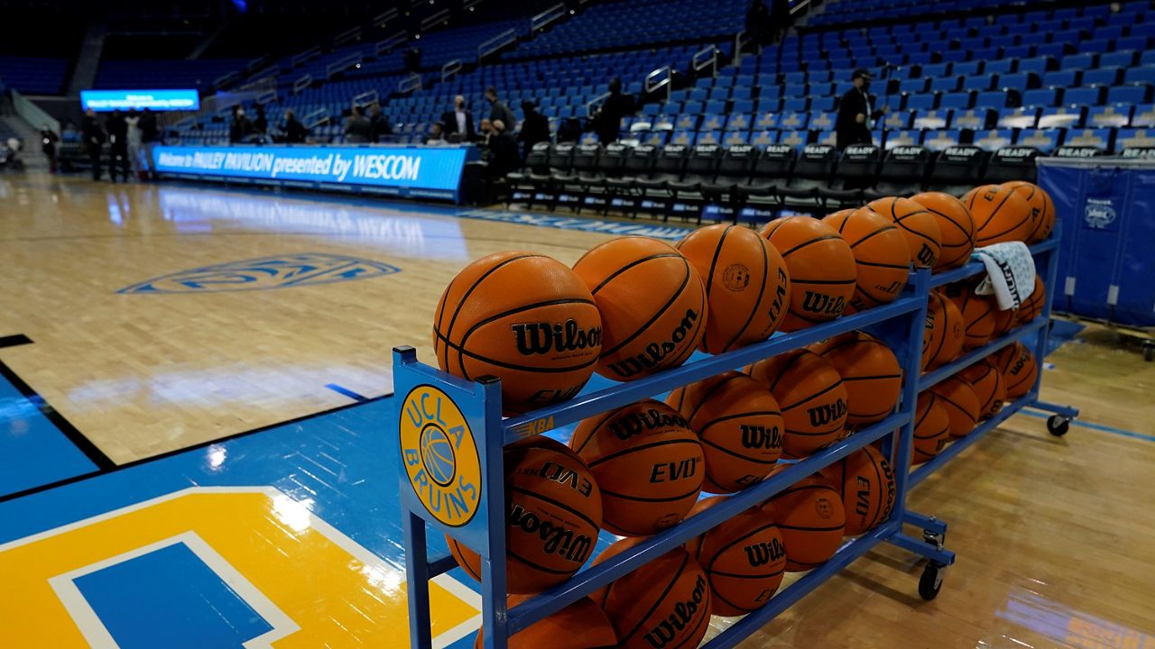 Basketballs are stacked on the baseline before an NCAA college basketball game between UCLA and Alabama State Wednesday, Dec. 15, 2021, in Los Angeles. (AP Photo/Marcio Jose Sanchez)