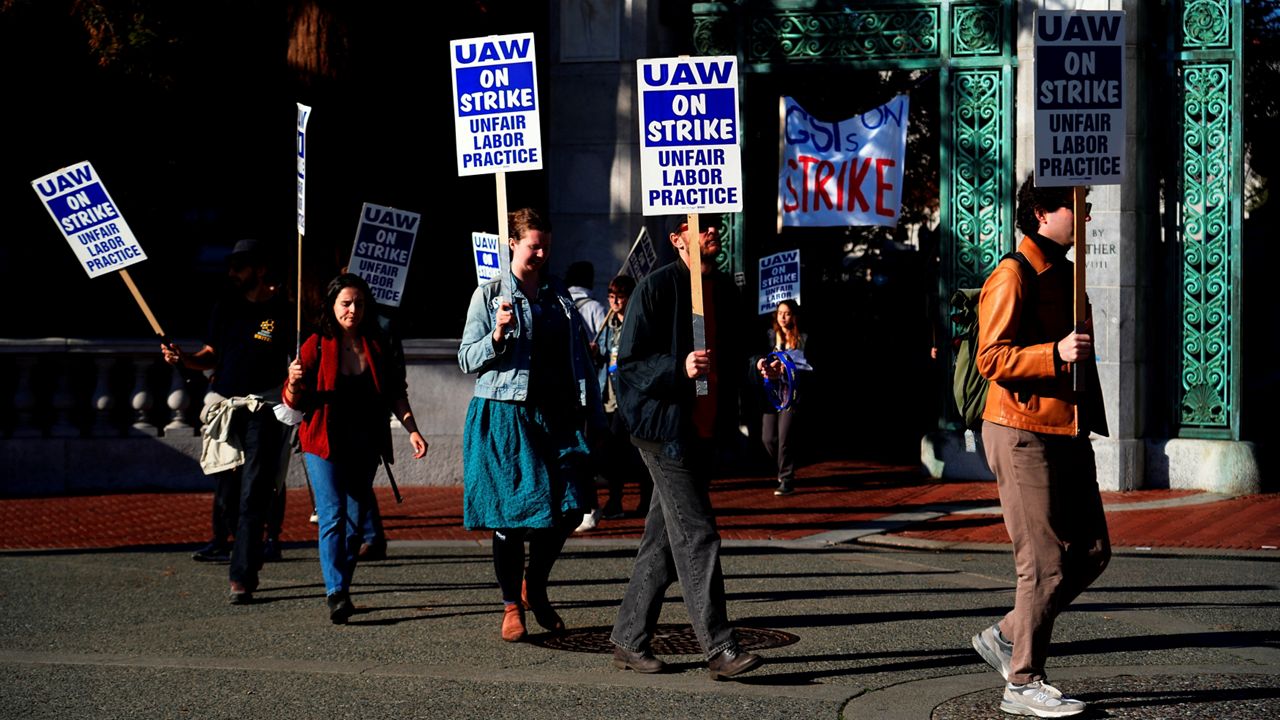 Graduate student instructors and researchers picket at University of California, Berkeley's Sather Gate during the fourth week of a strike by academic workers at the 10-campus UC system in Berkeley, Calif., Wednesday, Dec. 7, 2022. (AP Photo/Terry Chea)