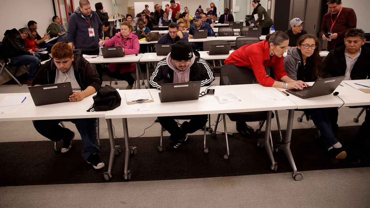 Unionized hospitality workers apply for unemployment benefits at the Hospitality Training Academy Friday, March 13, 2020, in Los Angeles. Fearing a widespread health crisis, Californians moved broadly Friday to get in front of the spread of the coronavirus, shuttering schools that educate hundreds of thousands of students, urging the faithful to watch religious services online and postponing or scratching just about any event that could attract a big crowd.(AP Photo/Marcio Jose Sanchez)