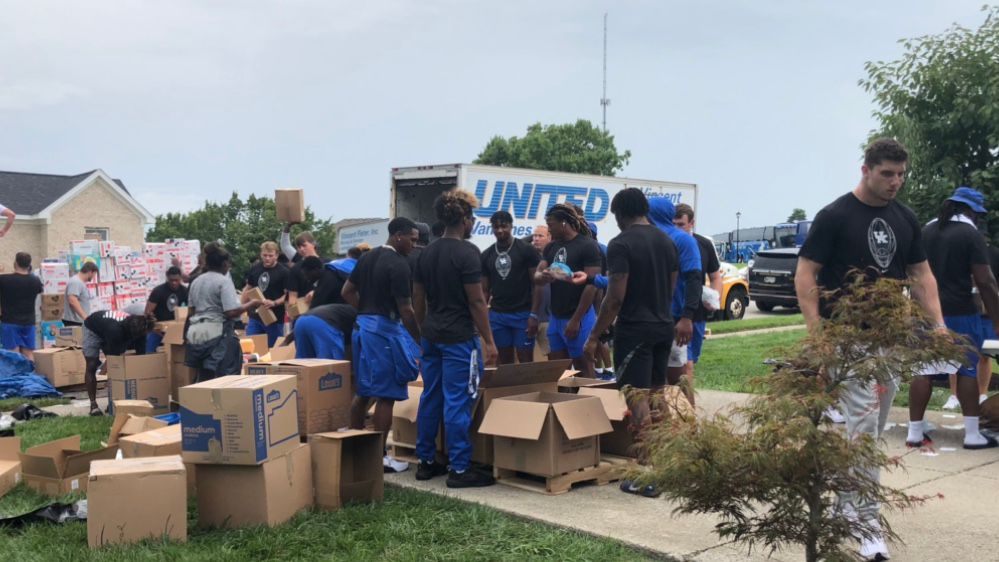 UK Football helps Father Sichko sort through donations