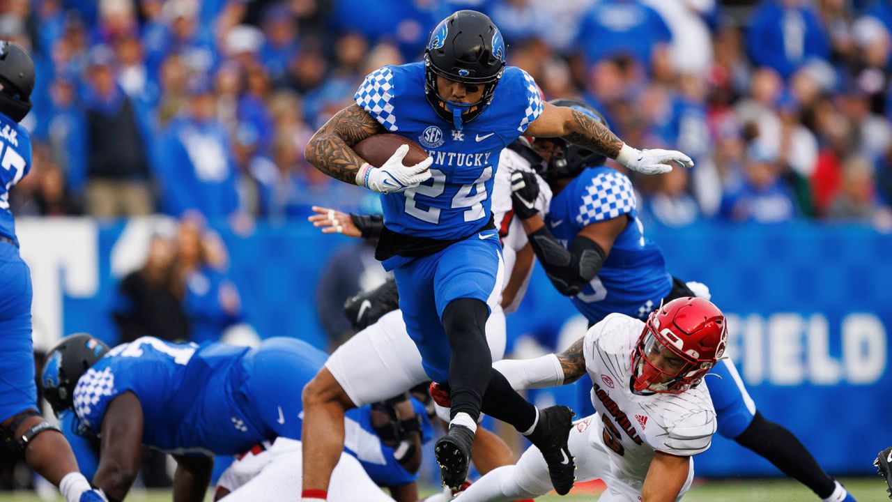 Kentucky running back Chris Rodriguez Jr. (24) evades a tackle during the first half of an NCAA college football game against Louisville in Lexington, Ky., Saturday, Nov. 26, 2022. (AP Photo/Michael Clubb)