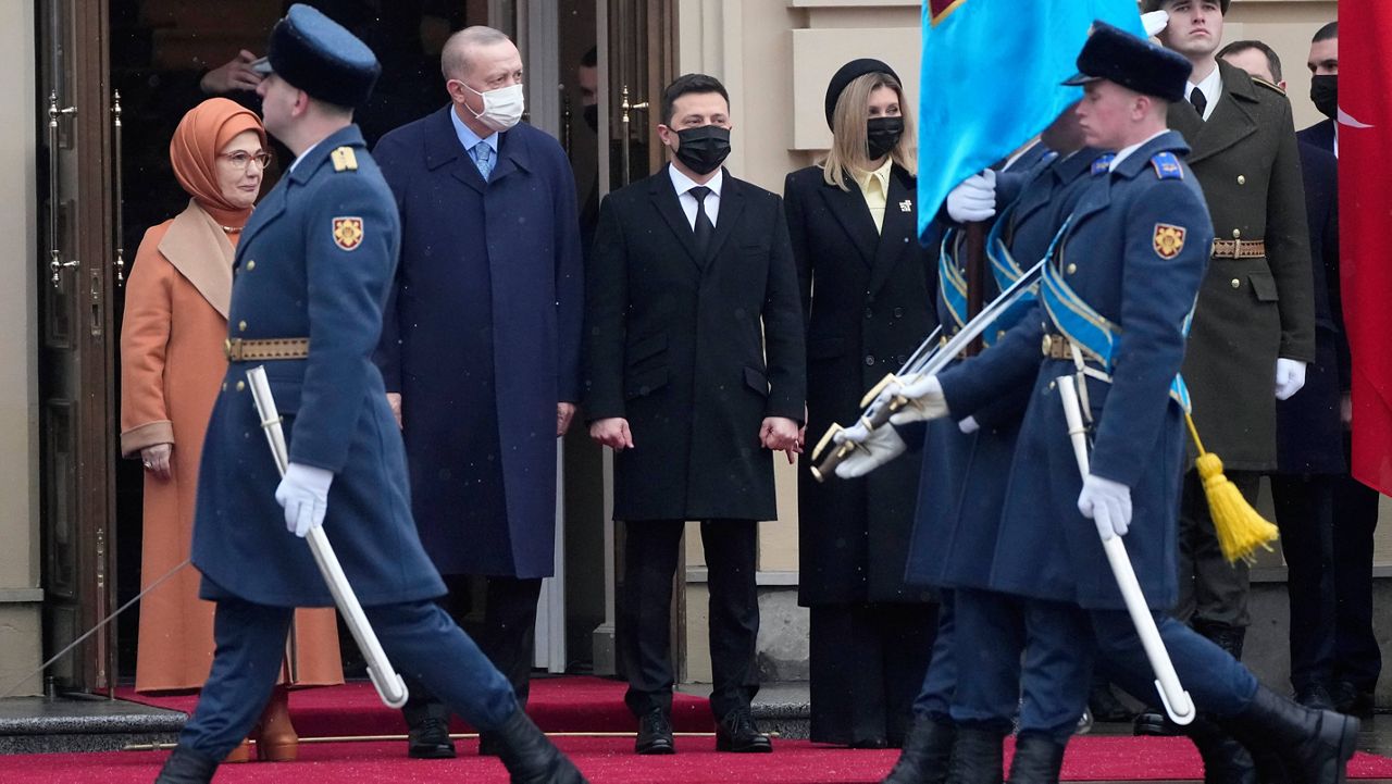 Ukrainian President Volodymyr Zelenskyy, center, his wife Olena, center right, Turkey's President Recep Tayyip Erdogan, center left, accompanied by his wife Emine, left, watch the honor guard Thursday during a welcome ceremony ahead of their meeting in Kyiv, Ukraine. (AP Photo/Efrem Lukatsky)