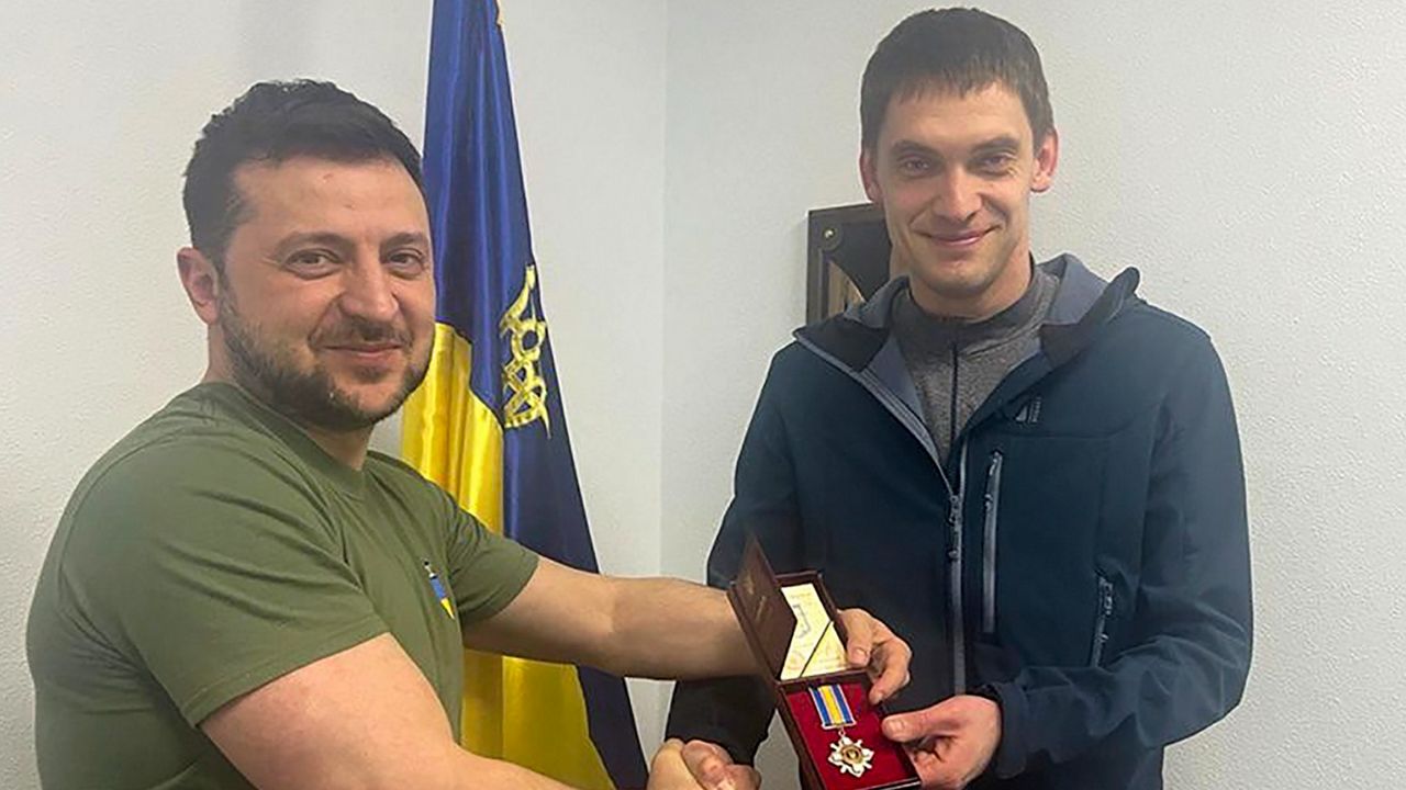 Ukrainian President Volodymyr Zelenskyy, left, awards Ivan Fedorov, mayor o...