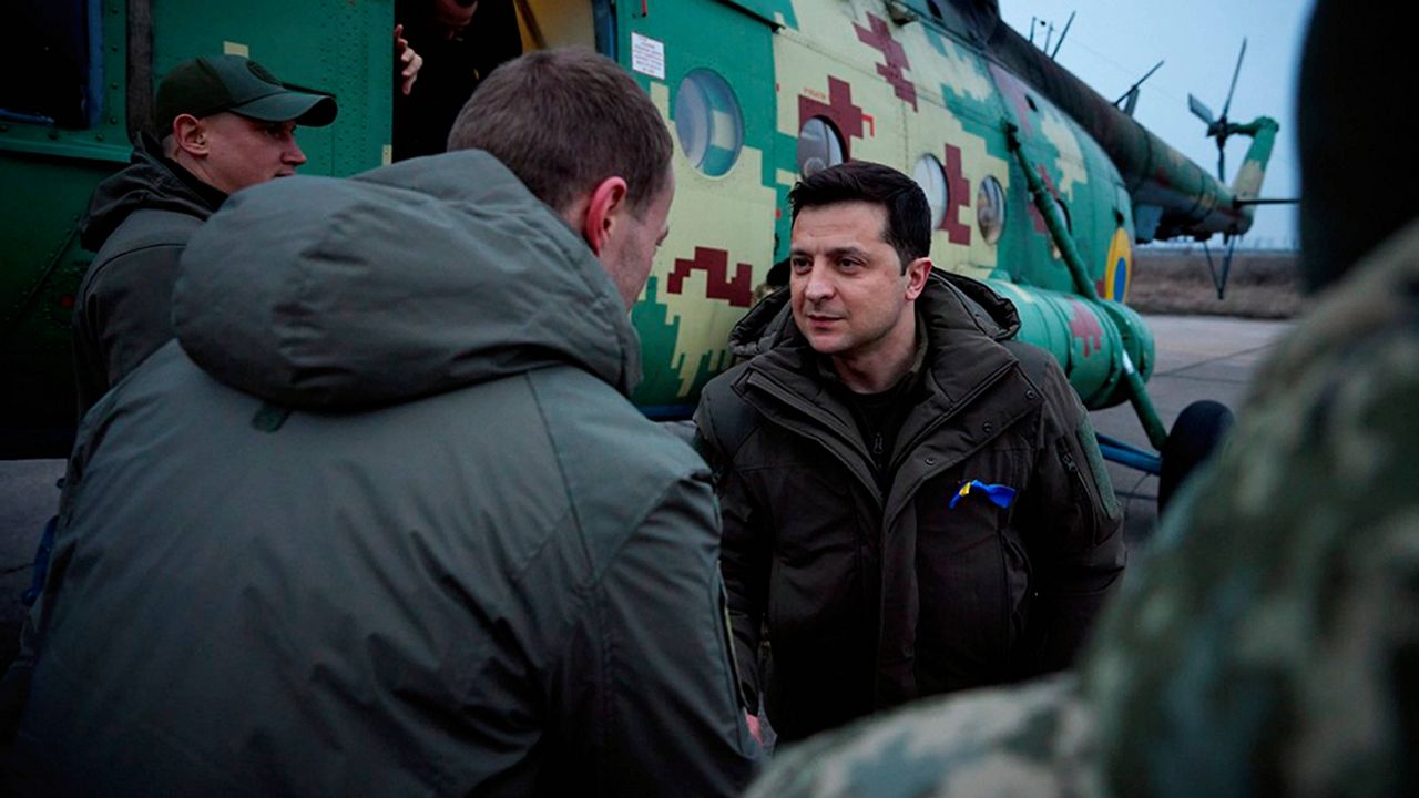 Ukrainian President Volodymyr Zelenskyy greets Ukrainian coast guards Thursday in Mariupol, Ukraine, in the Donetsk region. (Ukrainian Presidential Press Office via AP)