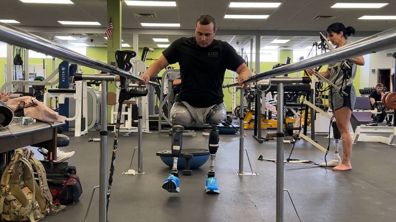 Ukrainian soldier Dmytro Nyshchuck tries out new prosthetic legs at Prosthetic and Orthotic Associates in Orlando. (Spectrum News/Jeff Allen) 