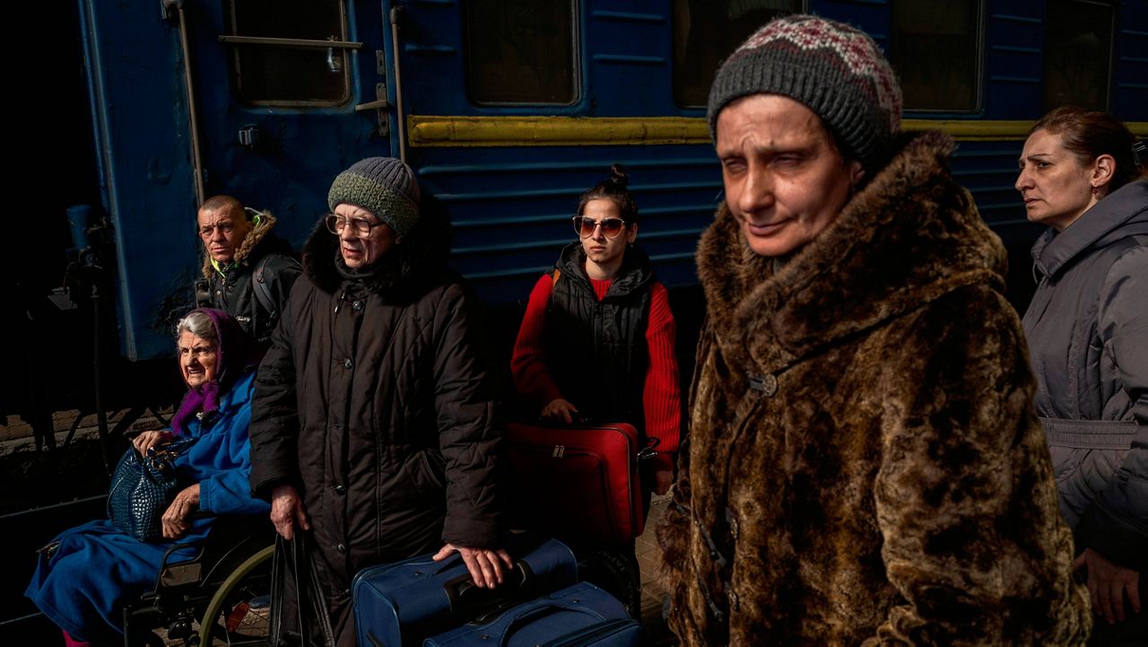 Ukrainians escaping from the besieged city of Mariupol, along with other passengers from Zaporizhzhia, arrive Sunday at Lviv, in western Ukraine. (AP Photo/Bernat Armangue)