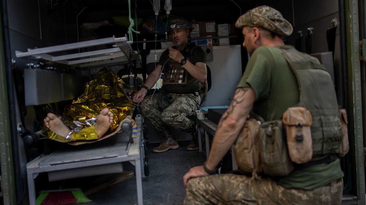 An injured Ukrainian serviceman is transferred to a medical facility Tuesday after receiving emergency medical treatment in the Donetsk region, in eastern Ukraine. (AP Photo/Bernat Armangue)