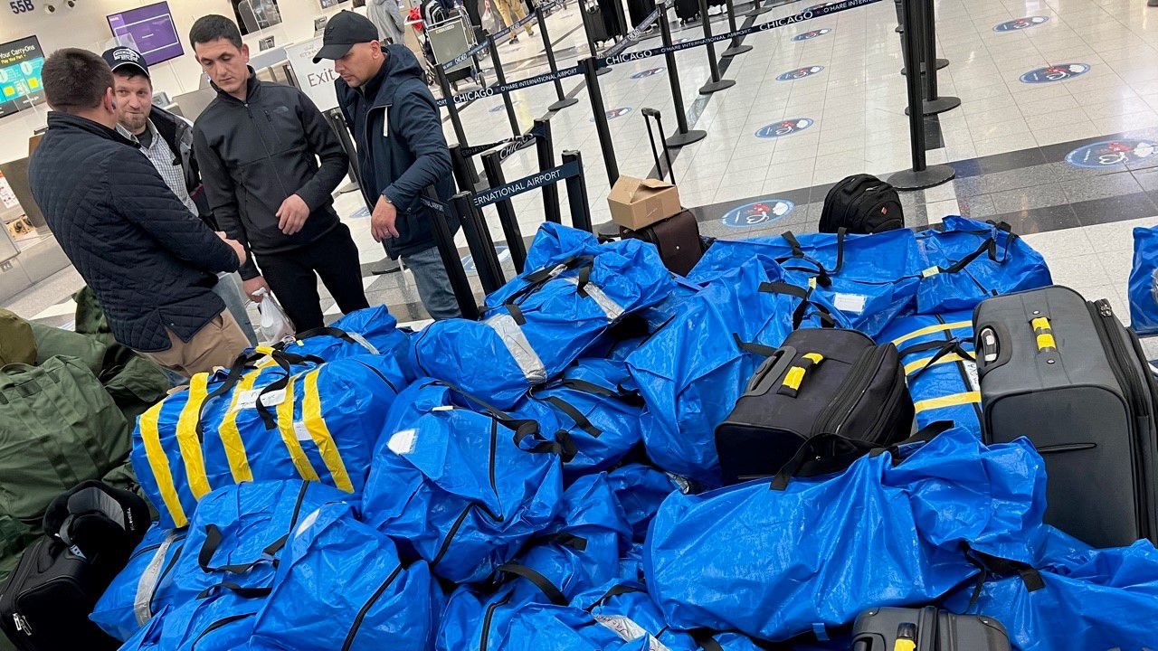 Members of Ukrainian Pentecostal Church of Nicholasville strategize a plan inside of Chicago O’Hare’s Airport before arriving in Warsaw, Poland. (Victor Selepina)