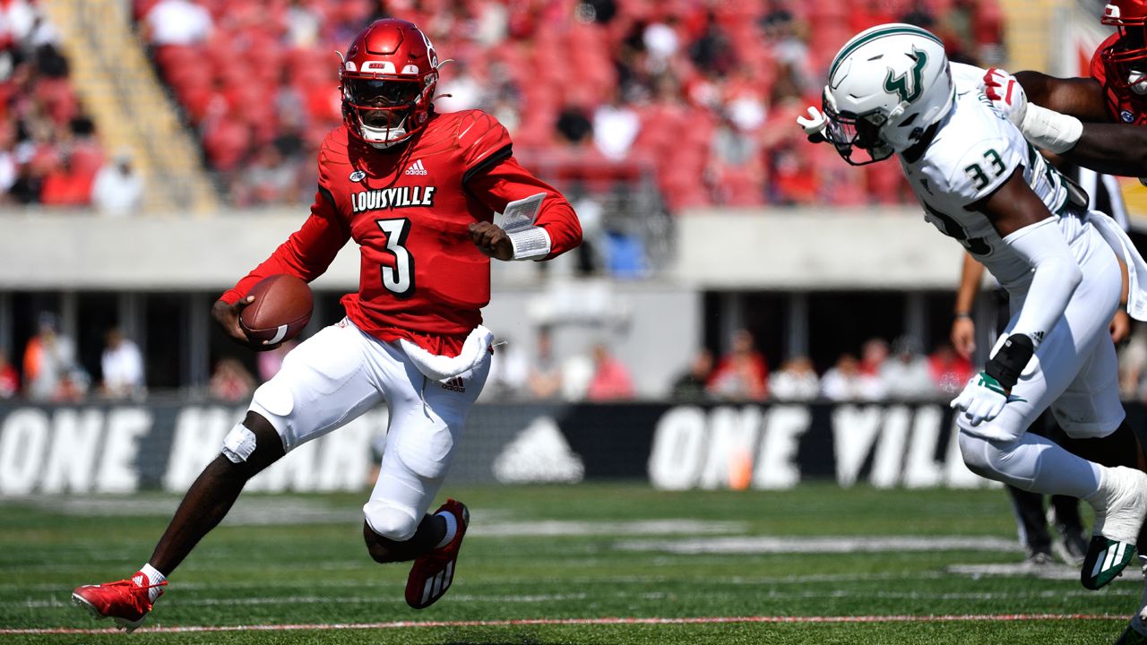 Louisville quarterback Malik Cunningham (3) is pursued by South Florida cornerback Timarcus Simpson (33) during the second half of an NCAA college football game in Louisville, Ky., Saturday, Sept. 24, 2022. Louisville won 41-3. (AP Photo/Timothy D. Easley)