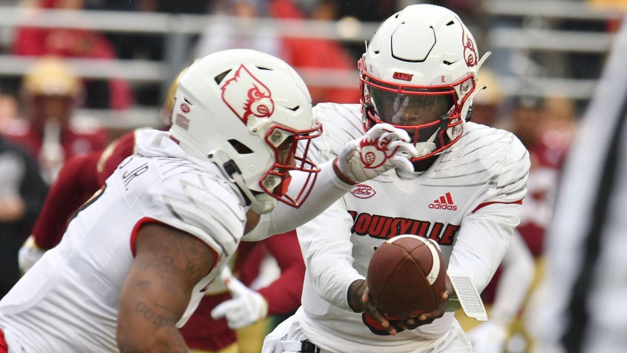 Louisville quarterback Malik Cunningham hands off the ball to Tyron Evans during the first half of an NCAA college football game against Boston College, Saturday, Oct. 1, 2022, in Boston. (AP Photo/Mark Stockwell)