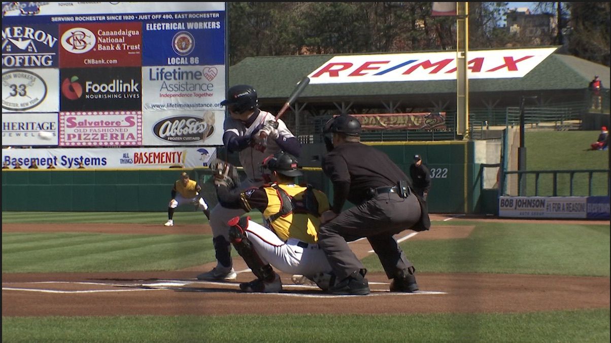 An umpire standing behind home plate