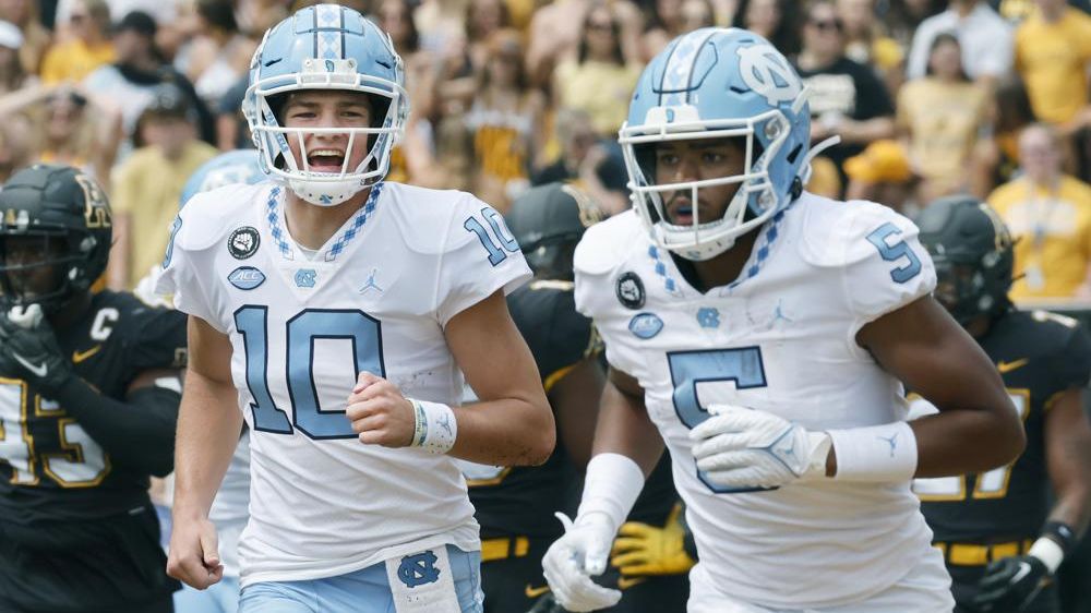 Drake Maye celebrates a touchdown, college football