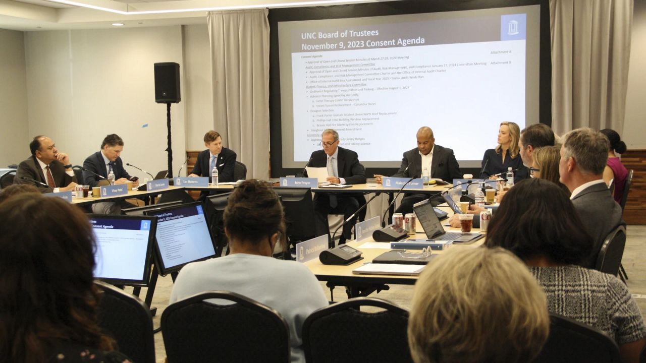 The University of North Carolina at Chapel Hill Board of Trustees convenes for a regular meeting at the UNC Center for School Leadership Development in Chapel Hill, N.C., on Thursday, May 16, 2024. The meeting came a few days after the board voted to cut $2.3 million of diversity spending to reallocate toward public safety. (AP Photo/Makiya Seminera)