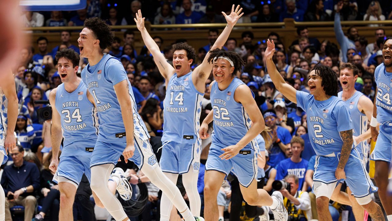 The North Carolina bench runs onto the court to celebrate after beating Duke in an NCAA college basketball game in Durham, N.C., Saturday, March. 9, 2024. (AP Photo/Ben McKeown)