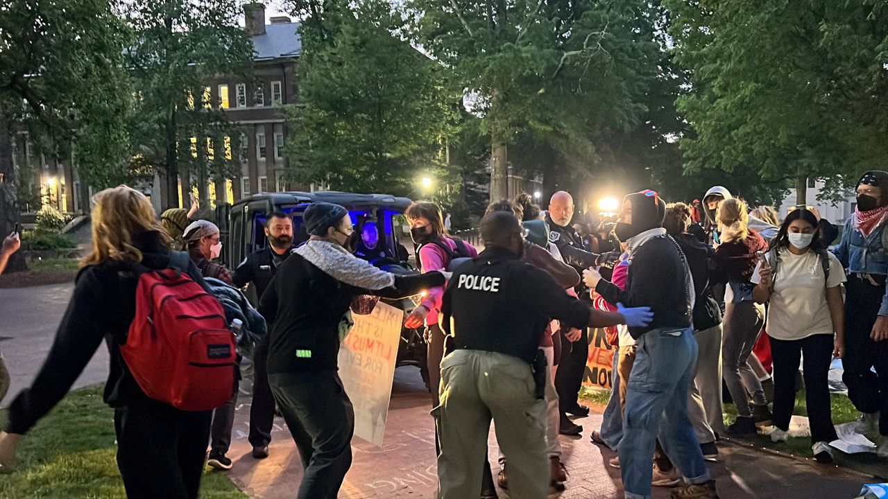 Protestors on the campus of UNC Chapel Hill clash with campus police Tuesday morning. (Spectrum News 1/Kyleigh Panetta)