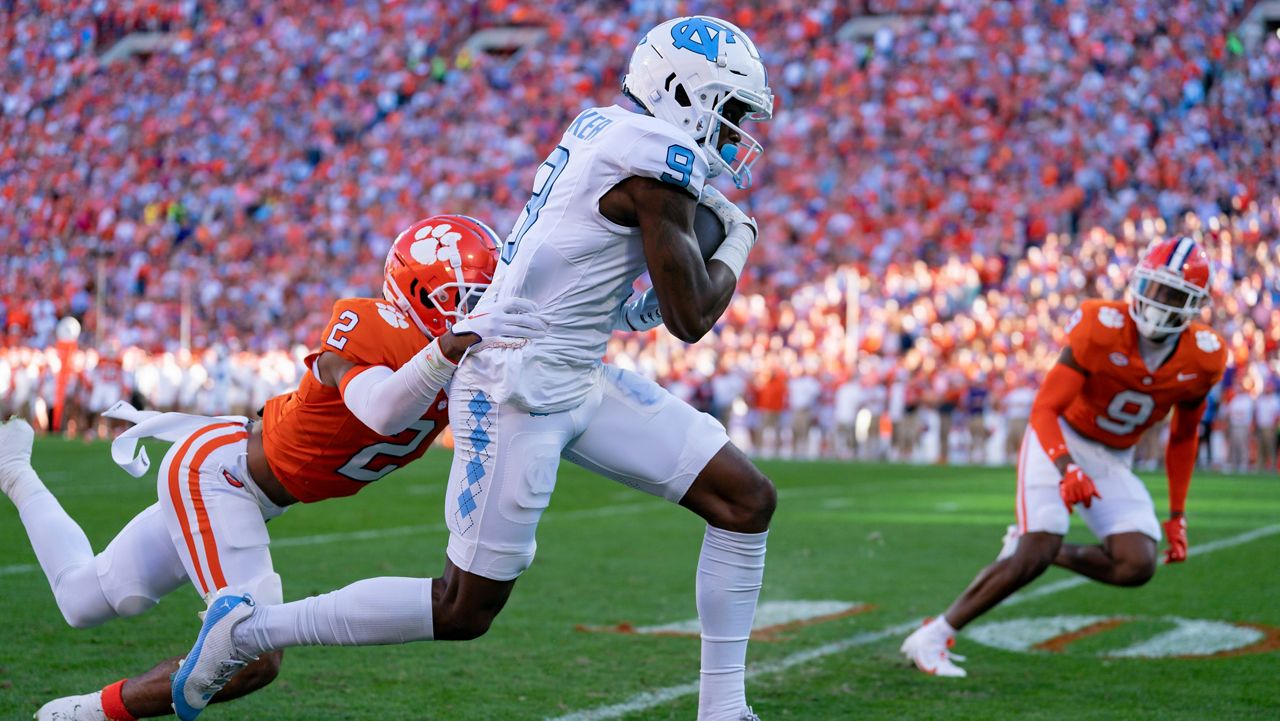 North Carolina wide receiver Devontez Walker (9) catches a pass while covered by Clemson cornerback Nate Wiggins (2) during an NCAA college football game Saturday, Nov. 18, 2023, in Clemson, S.C. (AP Photo/Jacob Kupferman)