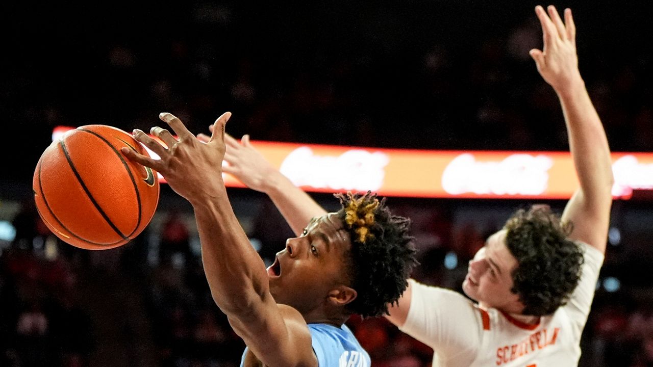 North Carolina forward Harrison Ingram (55) vies for a loose ball with Clemson forward Ian Schieffelin (4) during the first half of an NCAA college basketball game Saturday, Jan. 6, 2024, in Clemson, S.C. (AP photo/Mike Stewart)