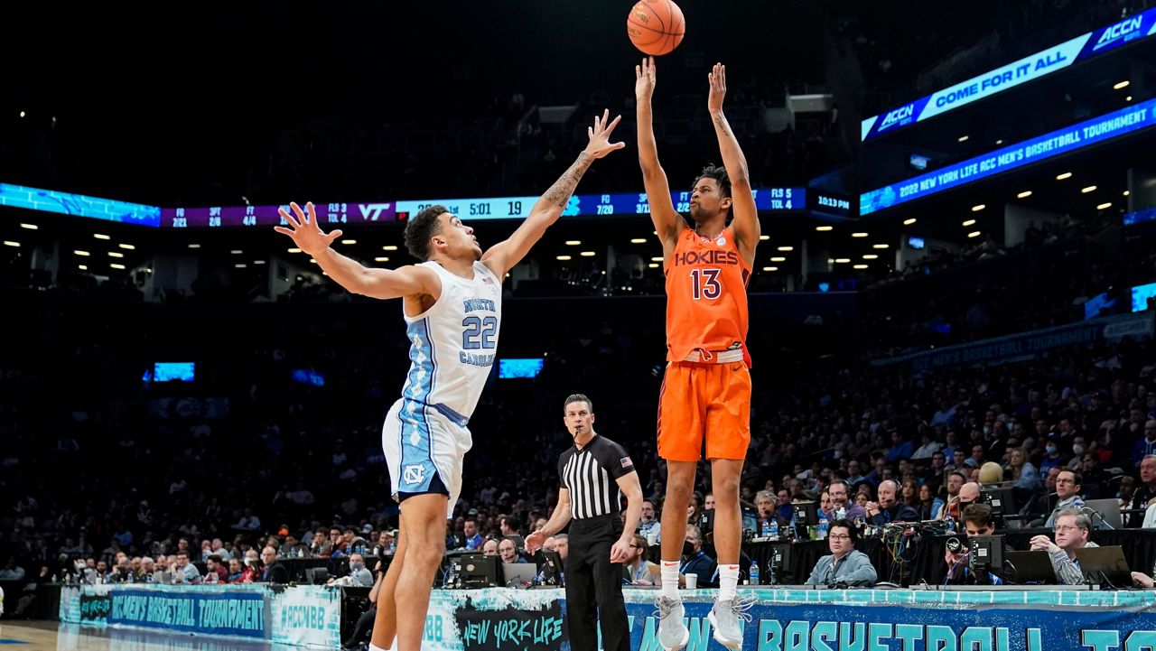 Virginia Tech's Darius Maddox (13) shoots against North Carolina's Justin McKoy (22) in an NCAA college basketball game during semifinals of the Atlantic Coast Conference men's tournament, Friday, March 11, 2022, in New York. (AP Photo/John Minchillo)