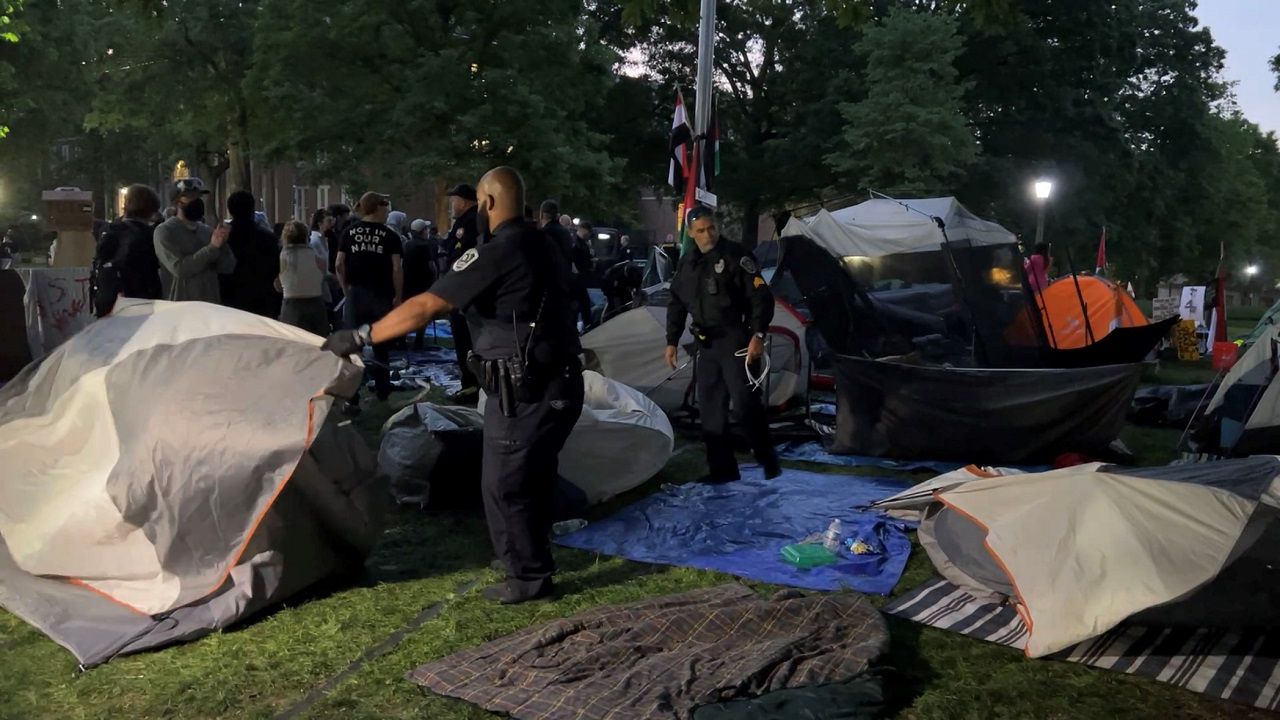 Police take down tents from a protest camp Tuesday morning at UNC. (Spectrum News 1/Kyleigh Panetta)