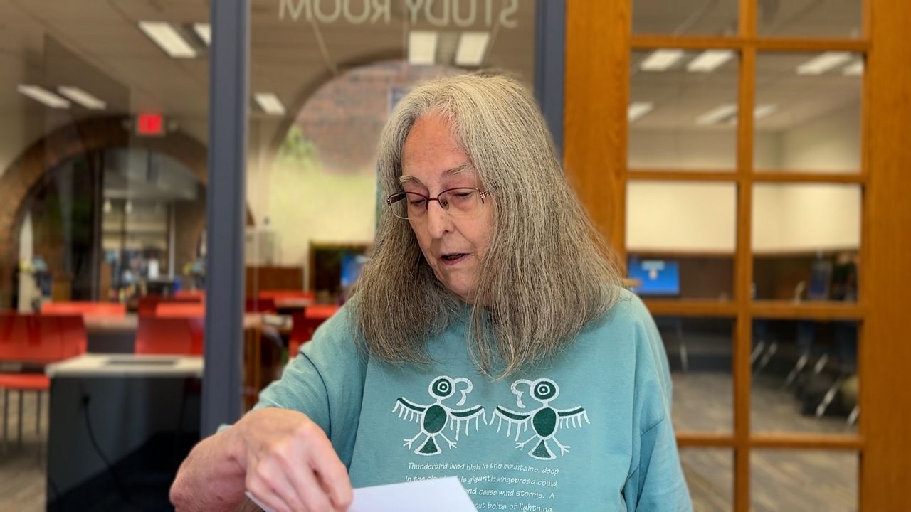 Rebecca Cotterman shows the check that reveals her money.