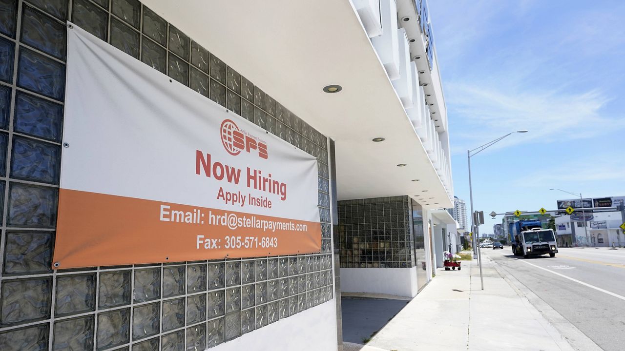 A "Now Hiring" sign is shown outside a business in Miami on April 7. (AP Photo/Wilfredo Lee) (AP Photo, File)