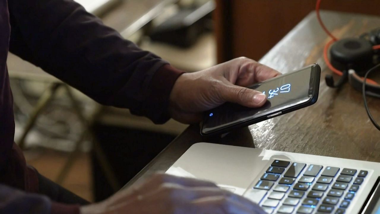 person on phone and computer 