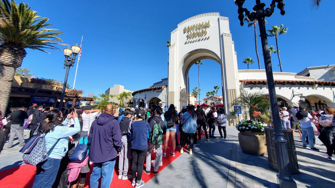 Customers wait in line to enter Universal Studios Hollywood. (Spectrum News 1/Joseph Pimentel)