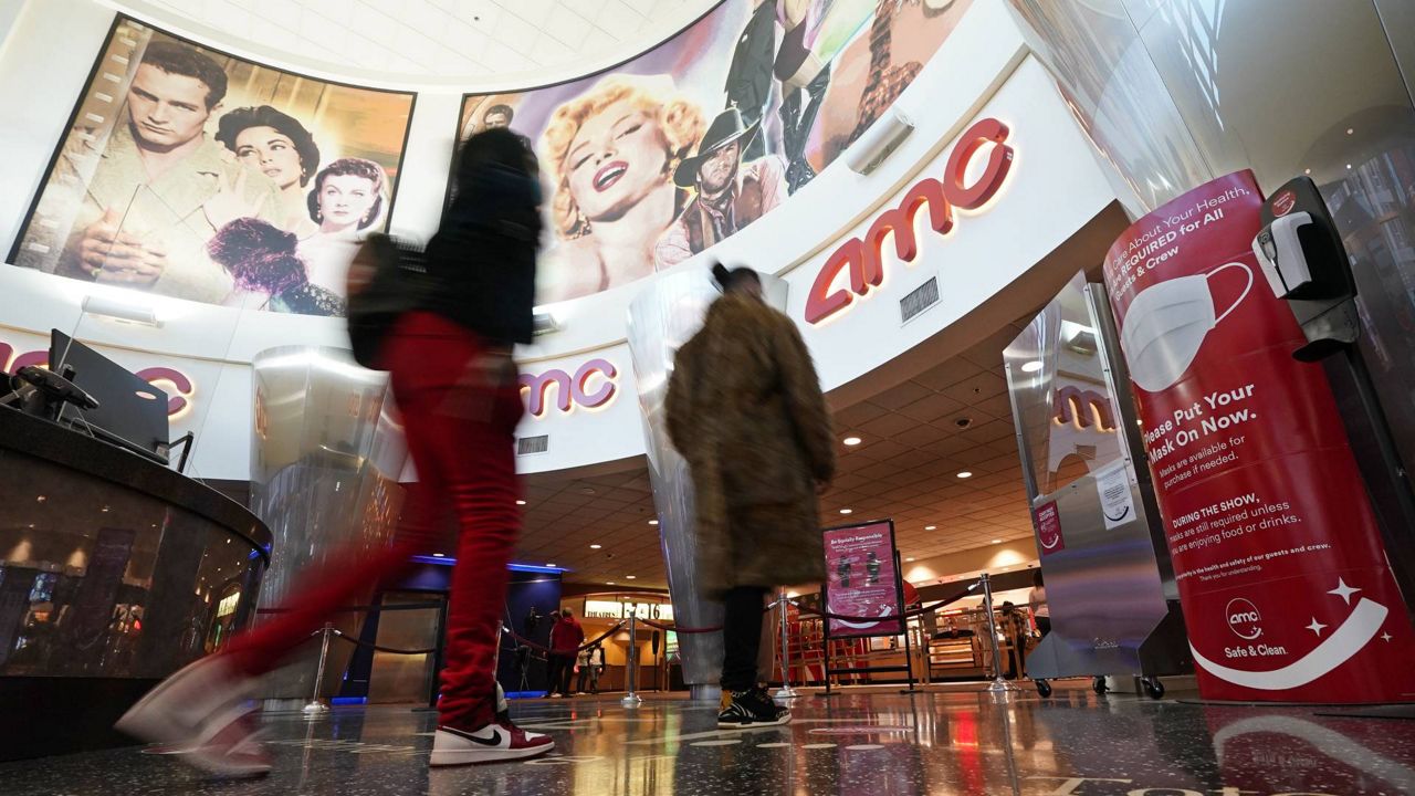 Movie patrons arrive to see a film at the AMC 16 theater, March 15, 2021, in Burbank, Calif. (AP Photo/Mark J. Terrill)