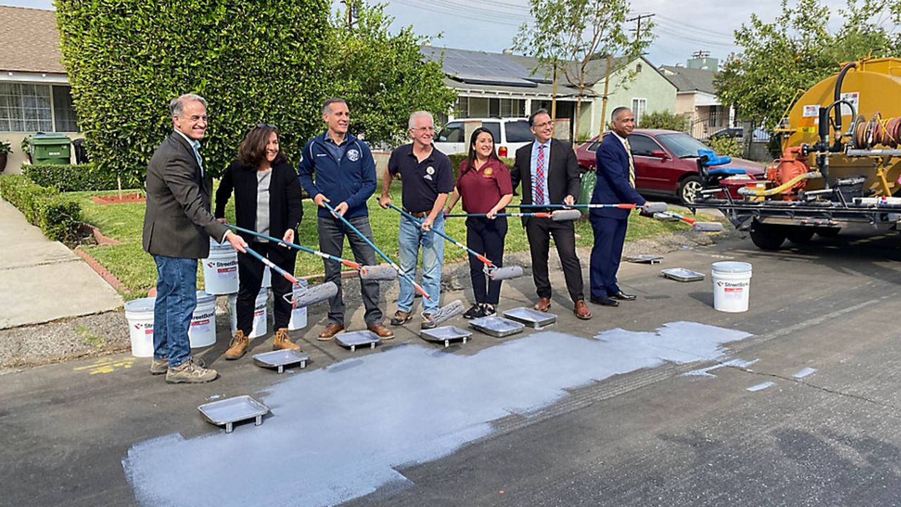 LA Mayor Eric Garcetti joins city leaders to add cool pavement to a street in North Hollywood. (Spectrum News/Susan Carpenter)