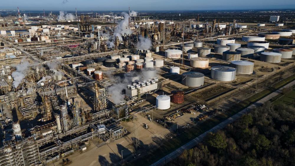 Smoke still fills the air at ExxonMobil’s refinery on Thursday, Dec. 23, 2021 in Baytown, Texas. Crews have extinguished a large fire at a Houston-area refinery that left four people injured. (Mark Mulligan/Houston Chronicle via AP)