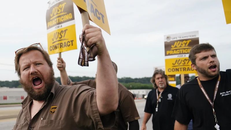 UPS teamsters and workers hold a rally, Friday, July 21, 2023, in Atlanta, as a national strike deadline nears. The Teamsters said Friday that they will resume contract negotiations with UPS, marking an end to a stalemate that began two weeks ago when both sides walked away from talks while blaming each other. (AP Photo/Brynn Anderson)