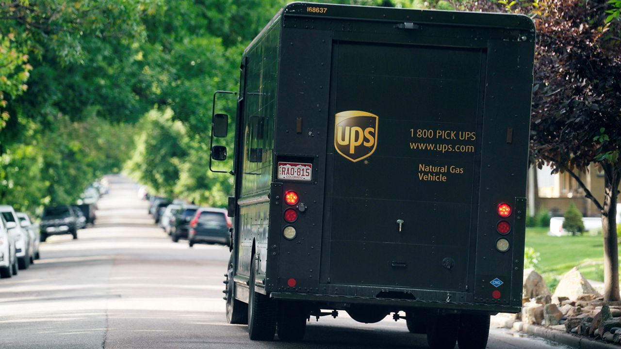 A UPS van comes to a stop to make a delivery. (AP Photo/David Zalubowski)